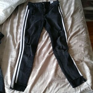 Black ripped jeans with white stripes on side
